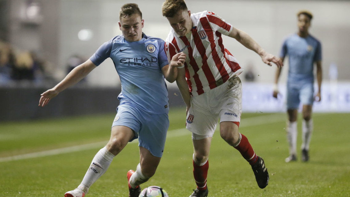 CHASING IT DOWN: Luke Bolton tests Stoke's defence during the first leg between the sides
