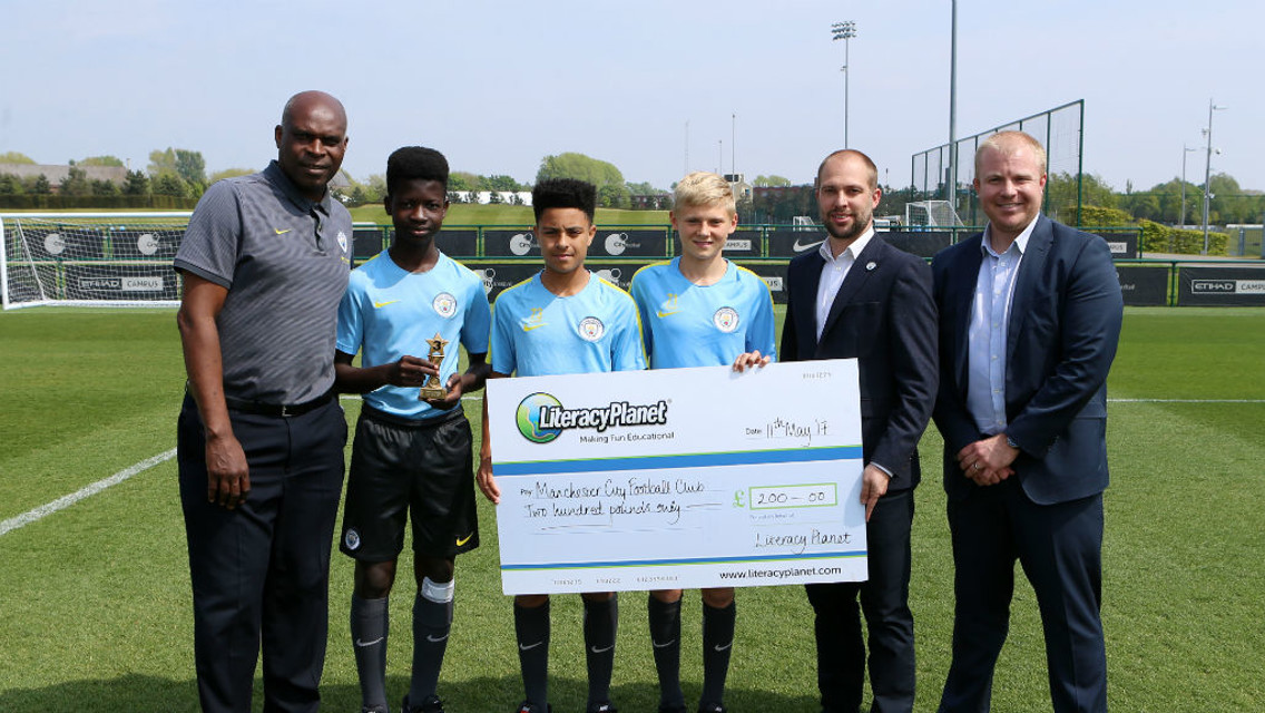 DONATION: Manchester City Academy collect their Word Mania literacy prize, which they have given to City in the Community.