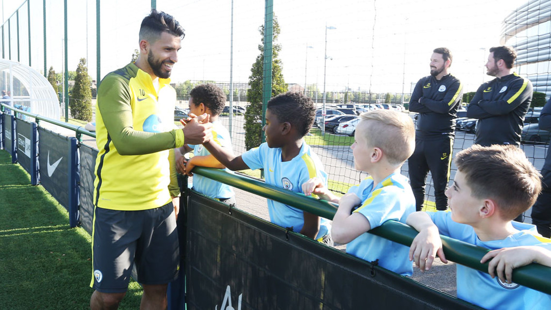 MEETING YOUR HEROES: Sergio Aguero shakes hands with some of the U8s academy team