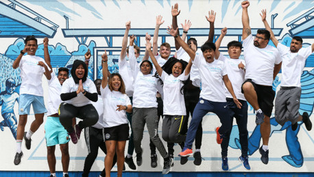 JUMPING FOR JOY: Some of our returning Young Leaders at the Community Wall at City Football Academy