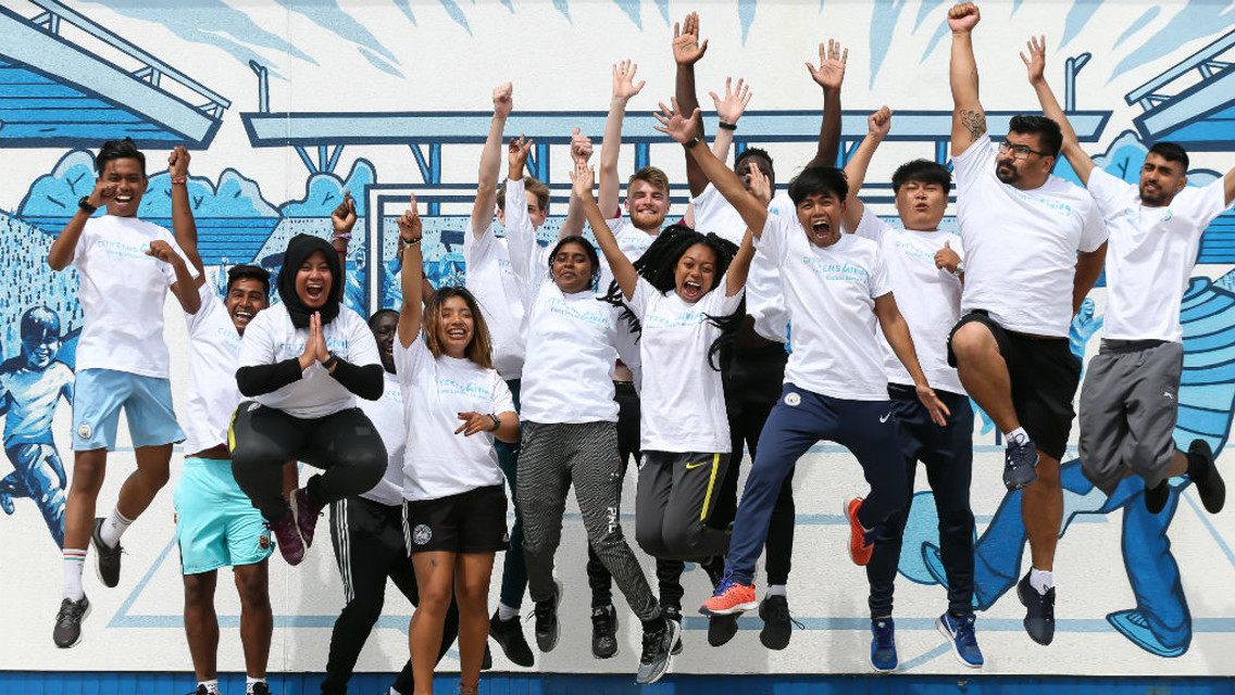 JUMPING FOR JOY: Some of our returning Young Leaders at the Community Wall at City Football Academy