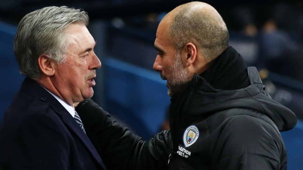 TACTICIANS : Guardiola and Ancelotti share a warm embrace ahead of kick off.