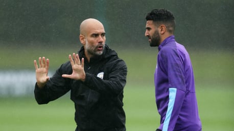 TALKING TACTICS: Pep Guardiola speaks to Riyad Mahrez on the training pitch.