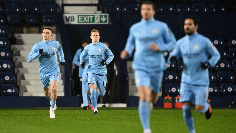 ARRIVAL : The players race out onto the pitch for the pre-match warm up.