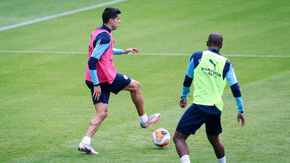 HEAD UP : Joao Cancelo studies what's in front of him.