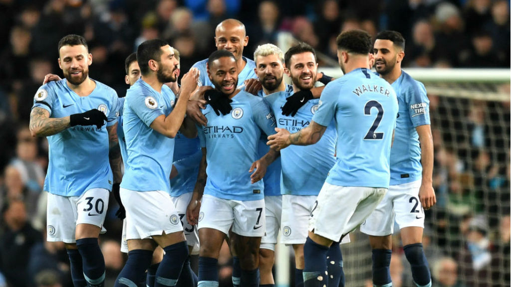CENTRE OF ATTENTION : Raheem Sterling is mobbed after his crucial opener