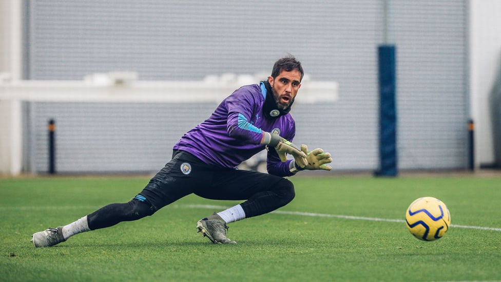 SAFE HANDS : Claudio Bravo gets down to smother the ball