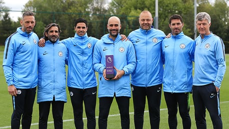 WINNER: Pep Guardiola celebrates his Manager of the Month award with his backroom staff.