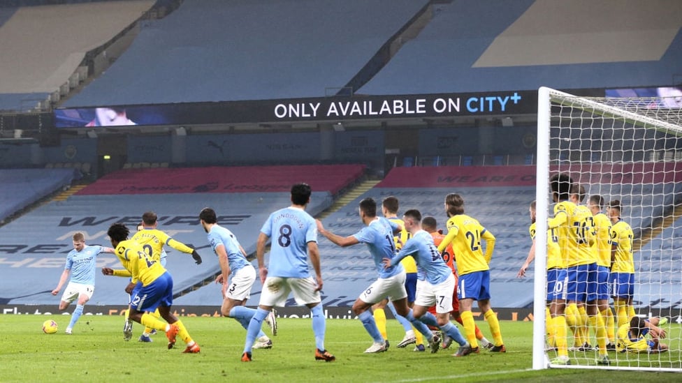 FULL HOUSE :  The players crowd the six yard box as De Bruyne's indirect free-kick is blocked.