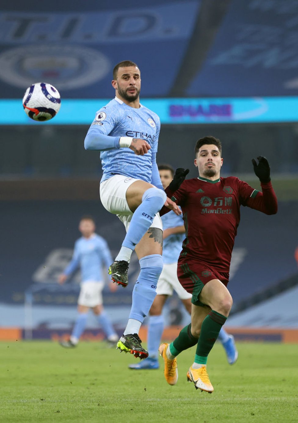 WALKER IN THE AIR: Kyle Walker brings the ball down under pressure from Pedro Neto