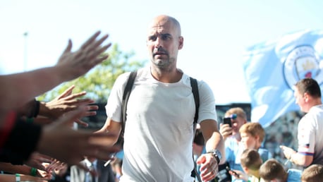 THE BOSS: Pep Guardiola greets the fans as he arrives at the Etihad