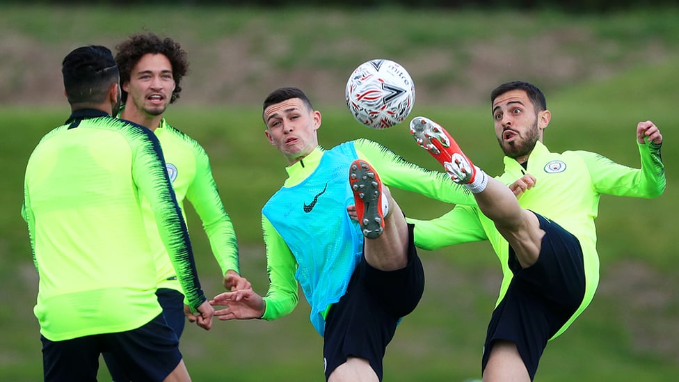 AT FULL STRETCH : Phil Foden and Bernardo Silva are in perfect synchronicity as they battle for the ball