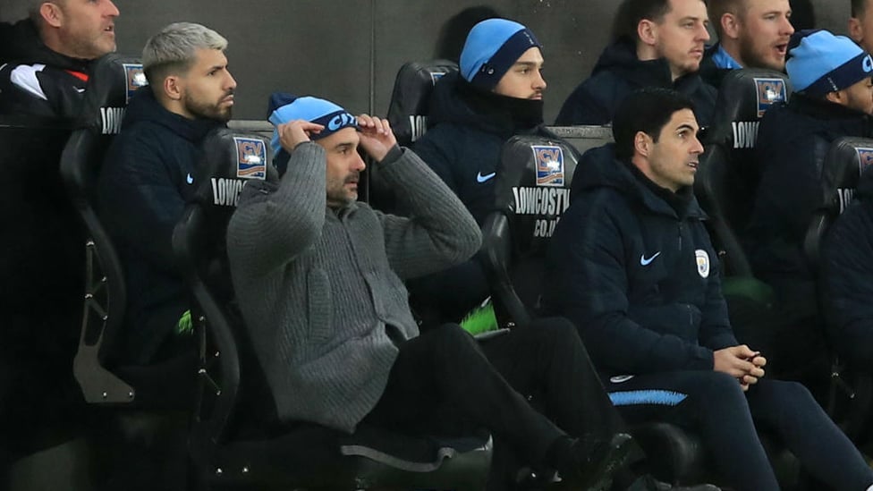 CHALLENGE : Pep Guardiola and the Blues bench look on in dismay after Swansea's second goal