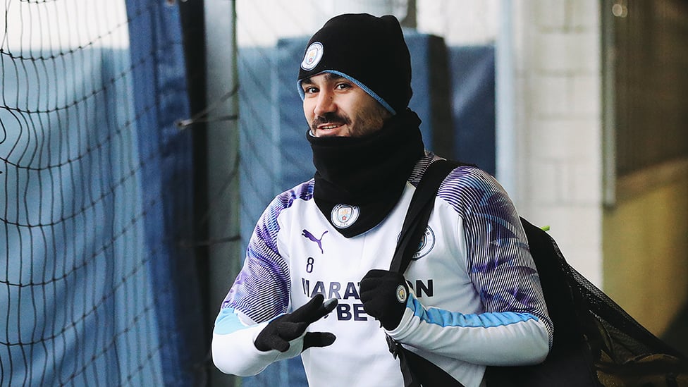IT'S A WRAP : Ilkay Gundogan is dressed to keep out the elements as he reports for duty
