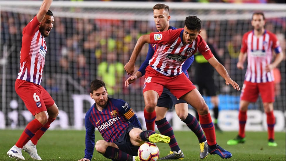 CENTRE OF ATTENTION : Rodri tussles with Lionel Messi during Atletico Madrid's clash with Barcelona last season