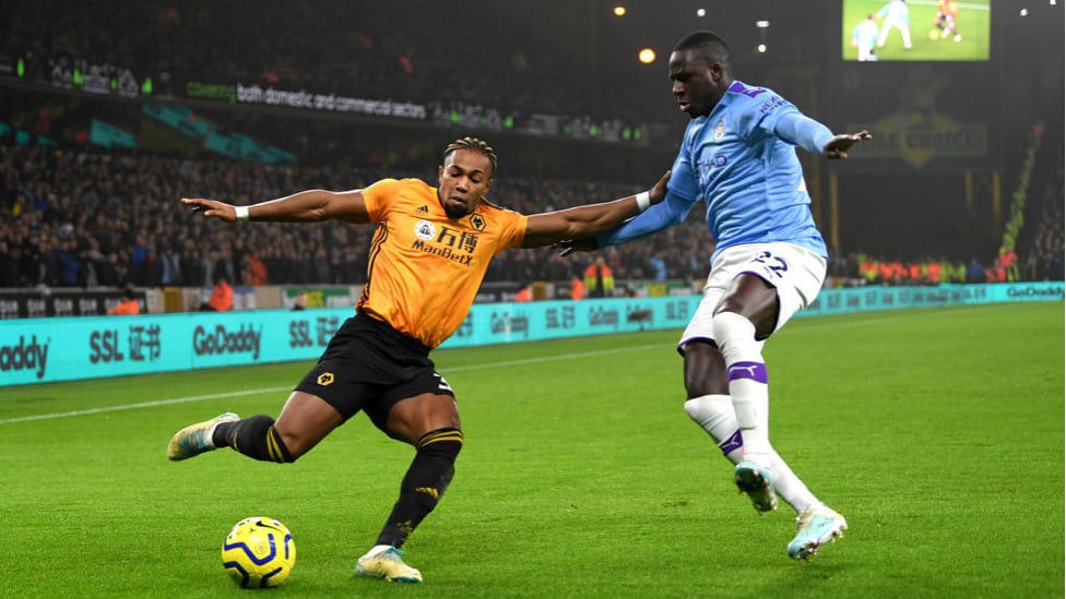 FLYING FULLBACK : Benjamin Mendy dives in to block an Adama Traore cross