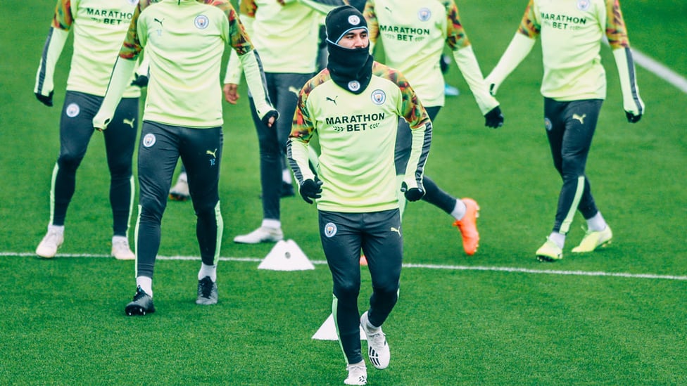 SNOOD OPERATOR : Ilkay Gundogan was well wrapped up to keep out the elements