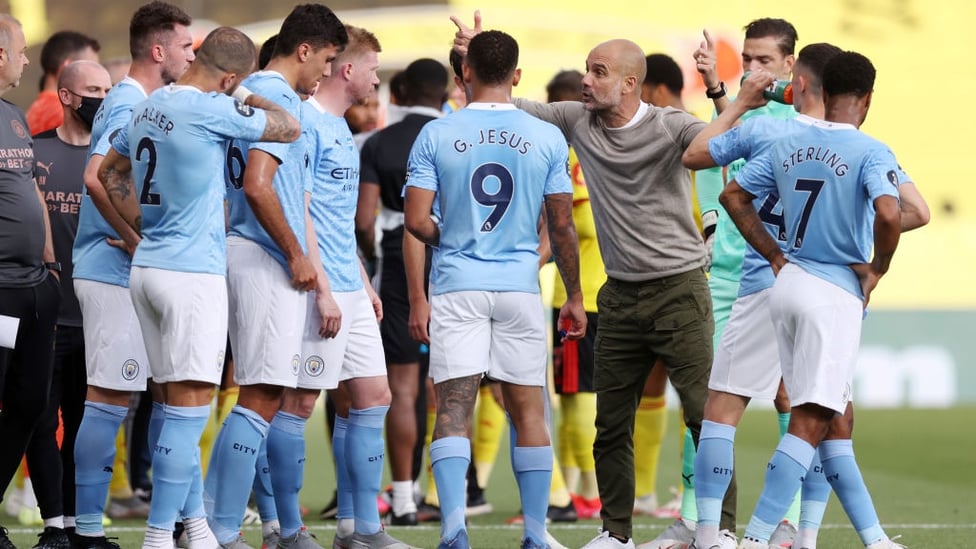 PEP TALK : Guardiola passes on instructions to the players during the first-half water break.