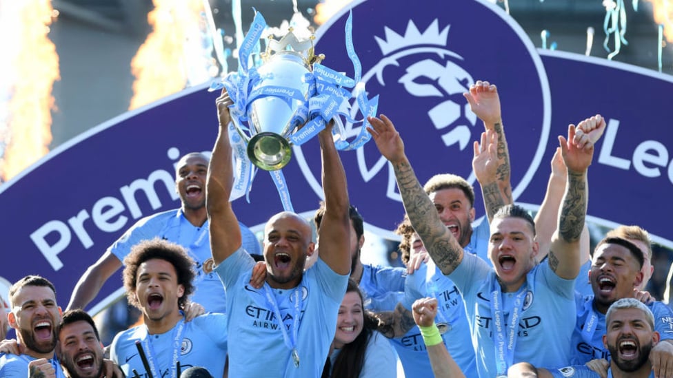 A LEAGUE APART : Kompany holds the Premier League trophy aloft after City's successful 2018/19 title defence