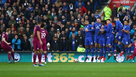 UP AND UNDER: Kevin De Bruyne leaves Cardiff's wall perplexed with a wonderful free kick.