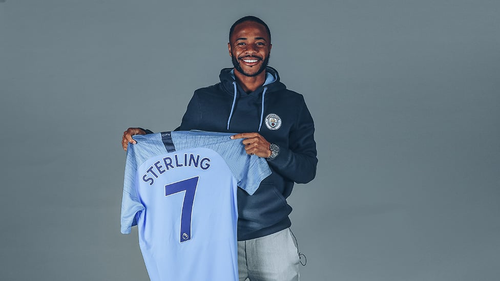 SEVEN HEAVEN : Raheem holds aloft a personalized City shirt