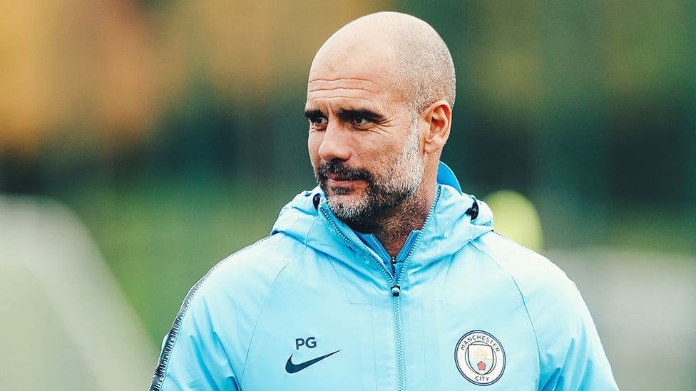 LEADING MAN : Pep Guardiola watches over the players as they go through their routines