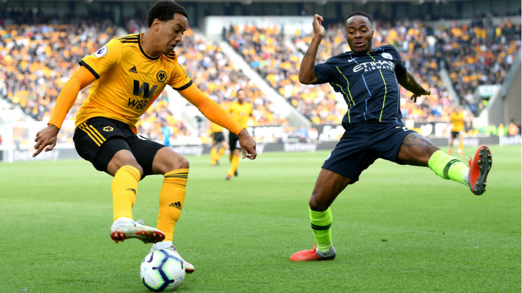 STOP START : Raheem Sterling is at full stretch at he looks to stop Helder Costa