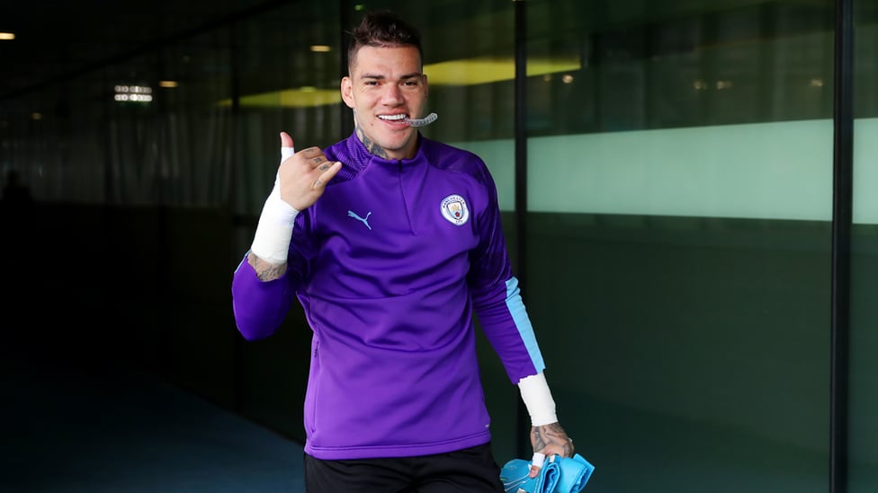 ALL SMILES : Ederson heads out for training.