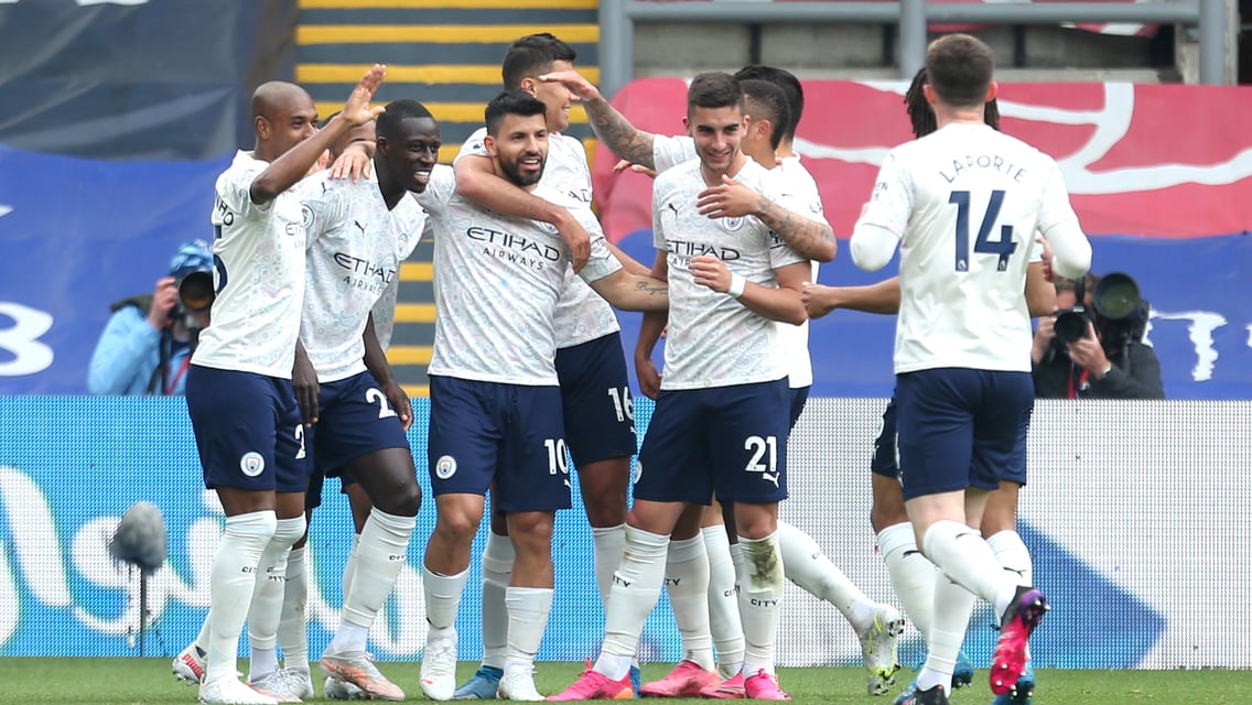 The City team congratulate Sergio Aguero on his super strike