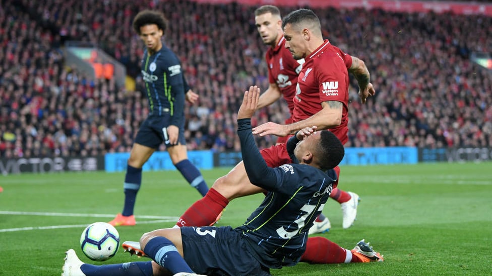 OUCH : Gabriel Jesus feels the force of a Dejan Lovren challenge