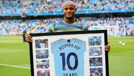 DECADE: Vincent Kompany received his gift for 10 years at the club before kick-off.
