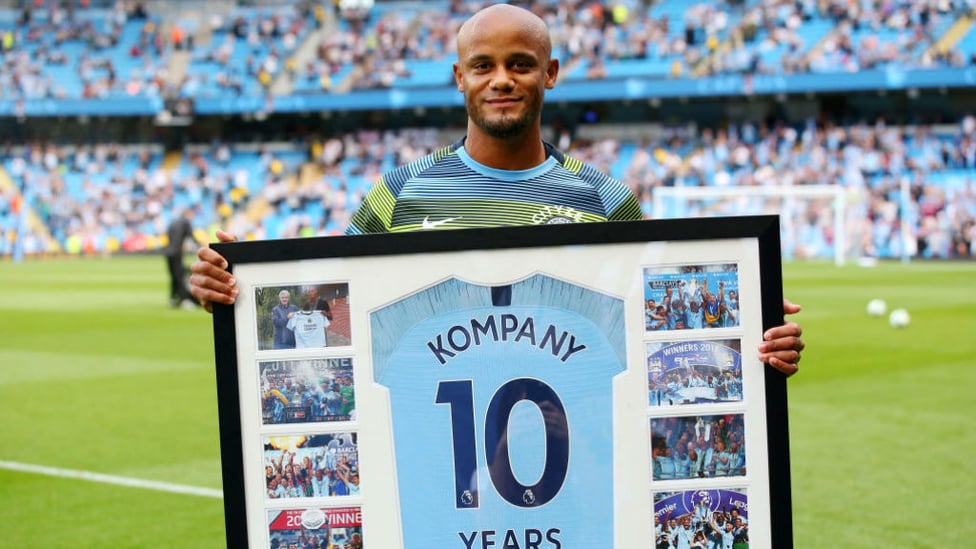 DECADE : Vincent Kompany received his gift for 10 years at the club before kick-off.