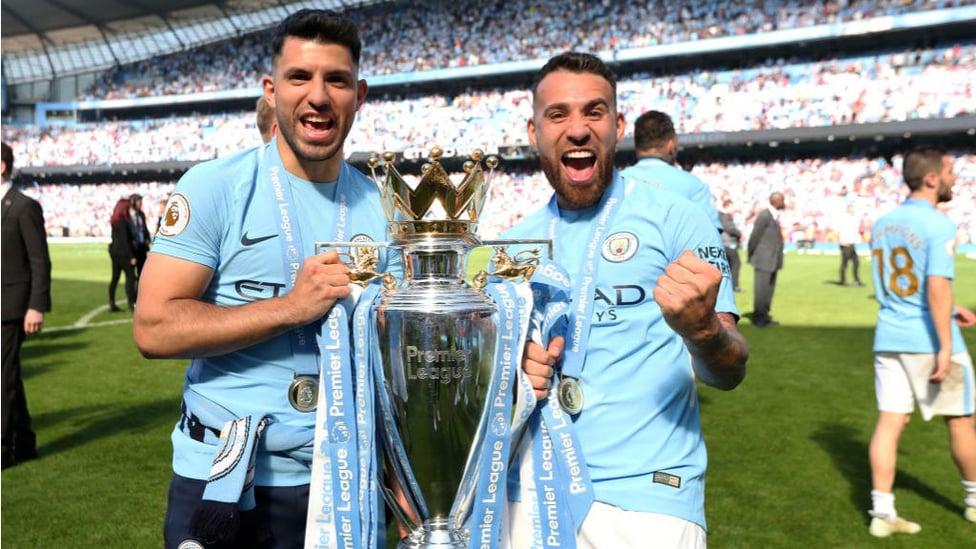 THREE CHEERS : Kun is all smiles after helping City clinch the Premier League title for a third time as he celebrates with Argentine colleague Nicolas Otamendi