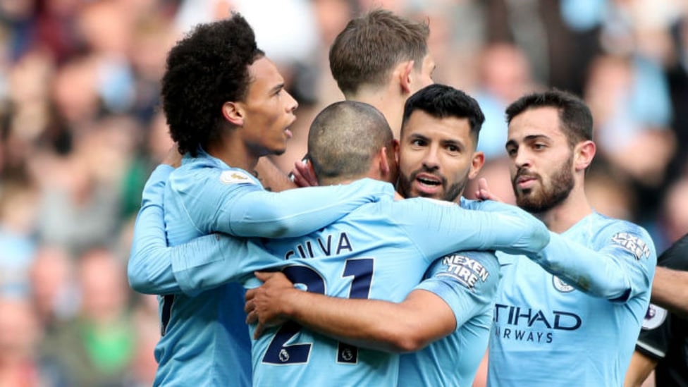 GIVE US A HUG : Sergio celebrates with his team-mates after his early strike