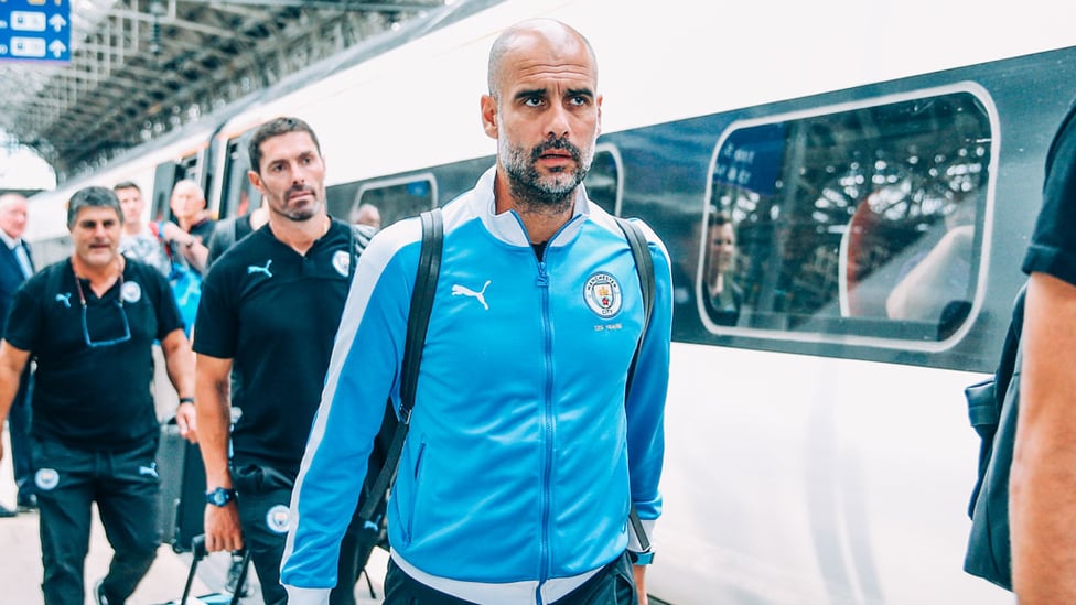 THE BOSS : Pep Guardiola prepares to board the train ahead of the journey to London