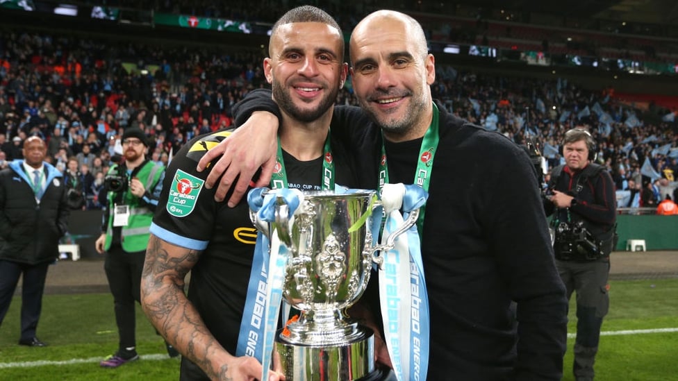 ALL SMILES : Walker and Guardiola strike a pose with the trophy.