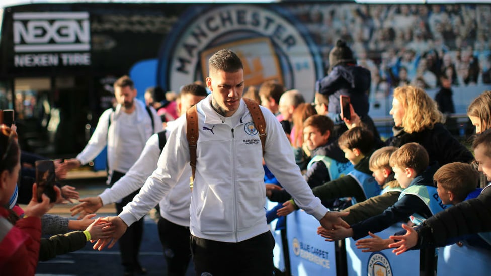 SAFE HANDS : Ederson greets the fans as he arrives at the Etihad.