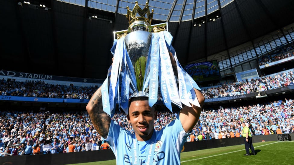 CHAMPIONS : Lifting the Premier League trophy.