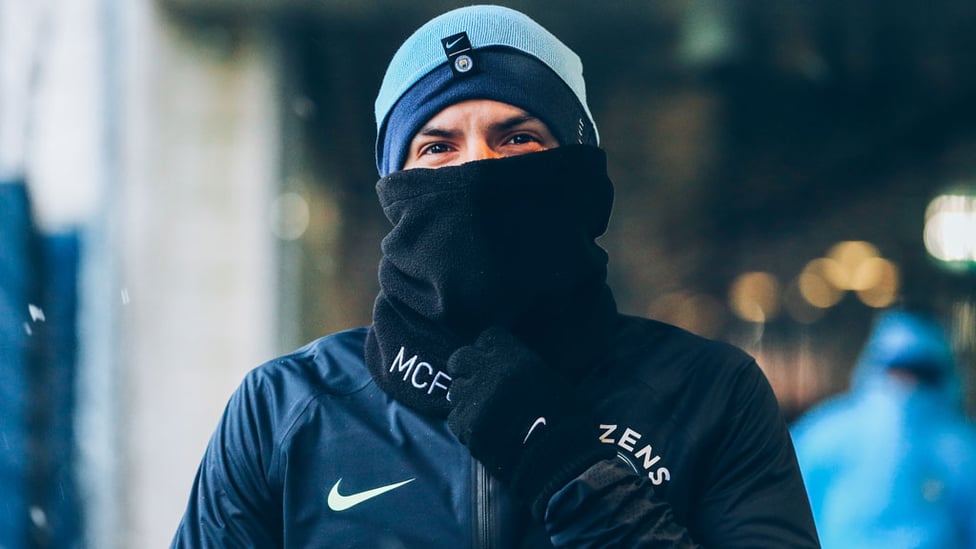 MASKED MARAUDER : Sergio Aguero prepares to face a snowy training session