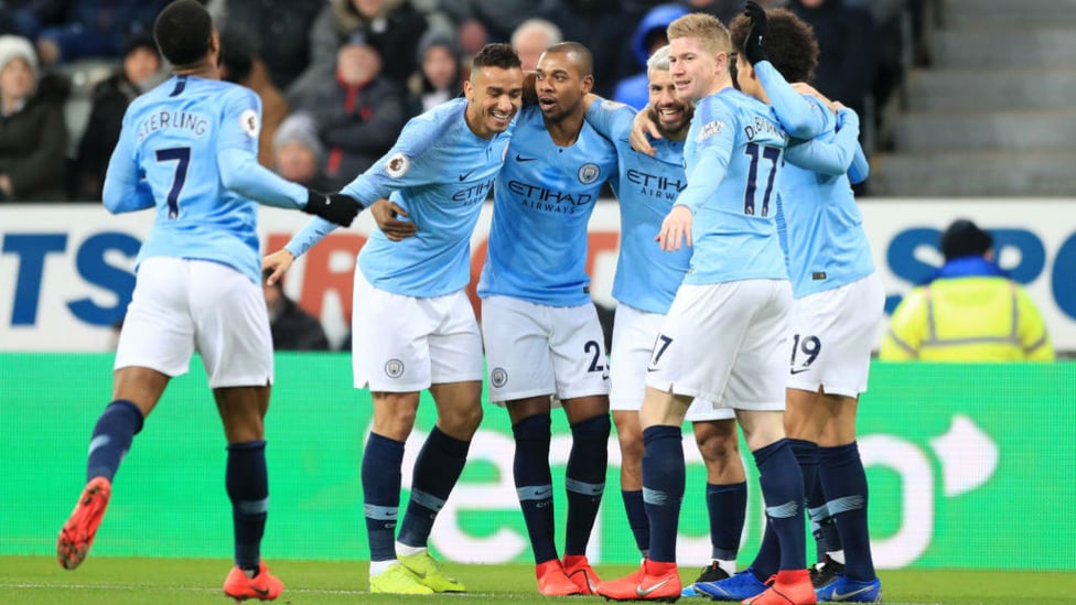 CELEBRATION : Aguero is congratulated by his teammates after giving City the lead