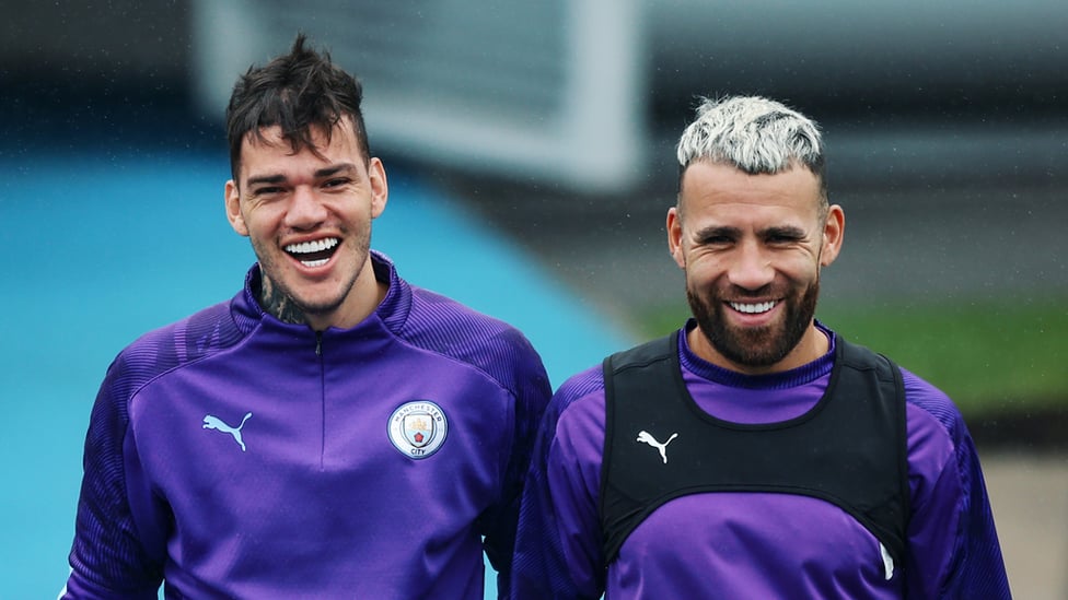 PEARLY WHITES : Ederson and Nicolas Otamendi share a joke