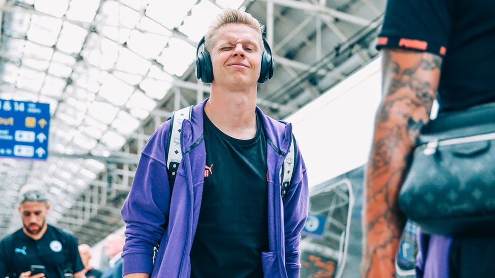 TUNES OF GLORY! Oleks Zinchenko is in relaxed mode as the City squad leave Manchester
