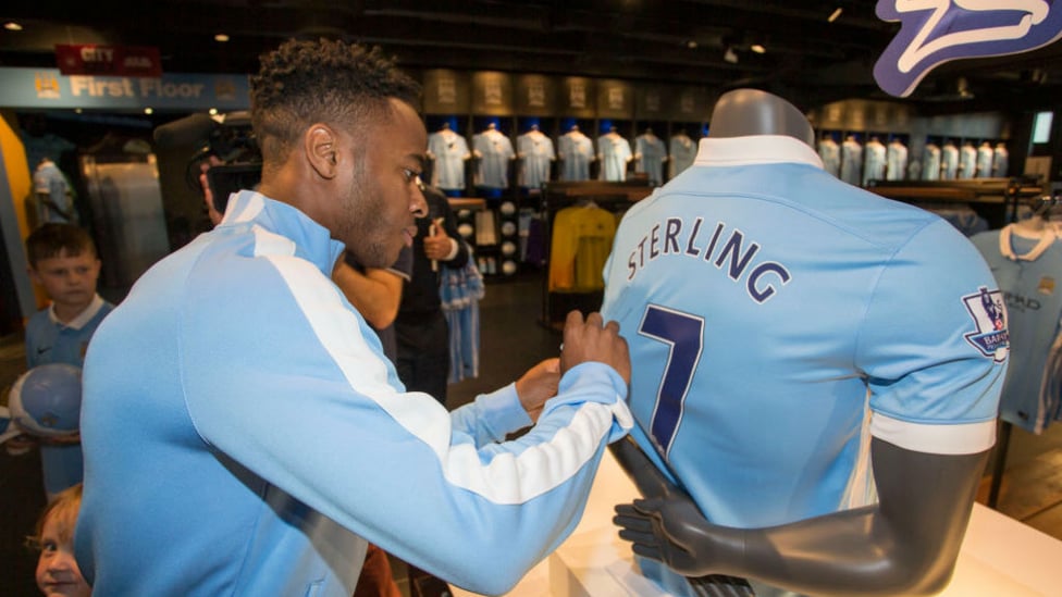 NEW RECRUIT : Sterling signs his jersey upon joining the club.