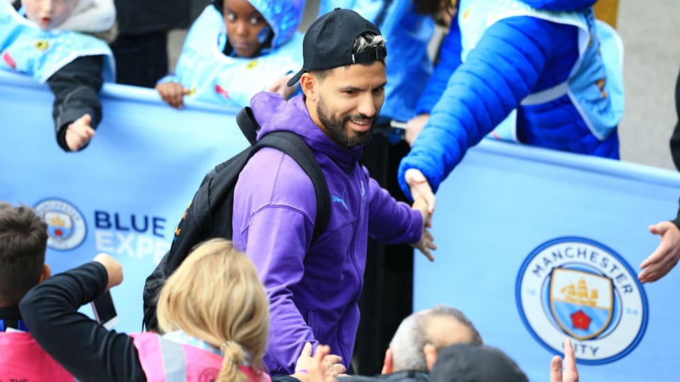 ALL SMILES : Aguero looks in relaxed mood as he arrives at the Etihad.