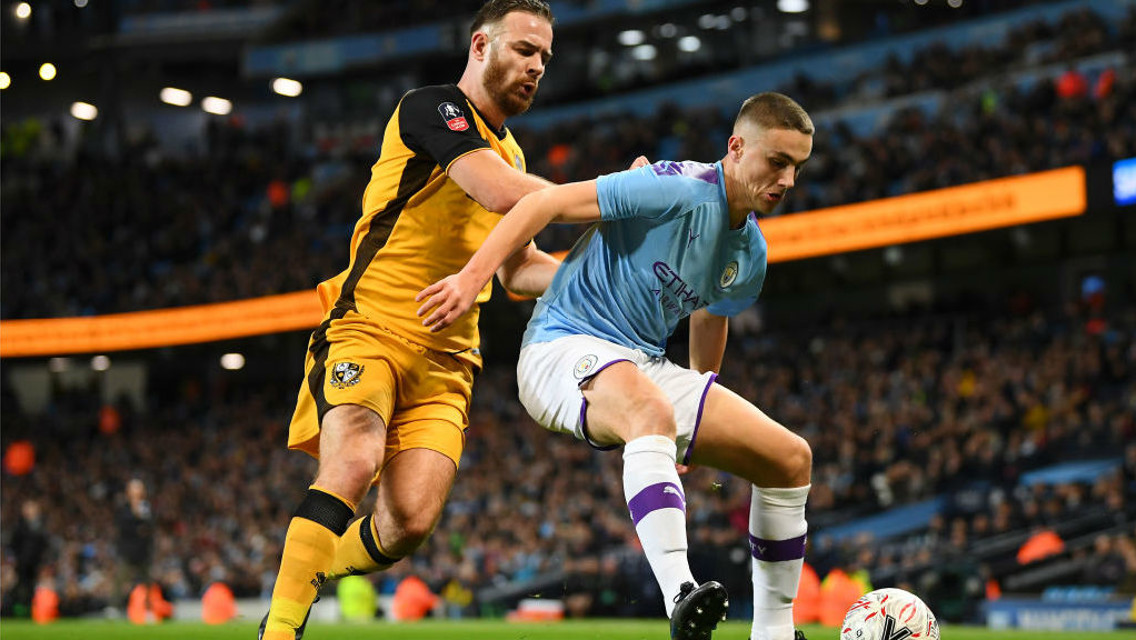 TAYLOR MADE: Taylor Harwood-Bellis shows his strength to hold off Port Vale striker Tom Pope