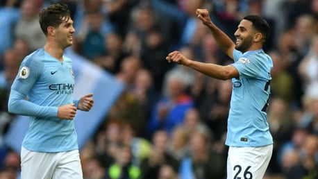 ALL SMILES: Riyad Mahrez celebrates with John Stones after his stunning strike