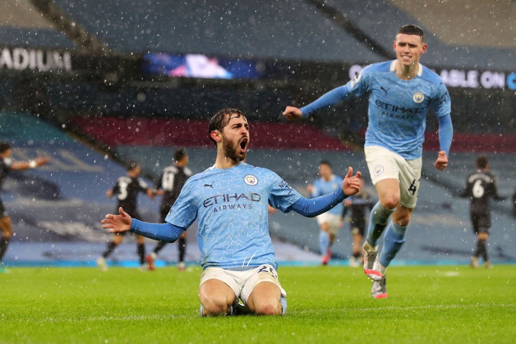 SLIDE RULE: Bernardo Silva and Phil Foden starts the celebrations after Bernardo's crucial strike