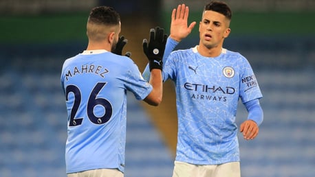 OVER AND OUT: Mahrez and Cancelo celebrate the victory as the referee blows the full-time whistle.