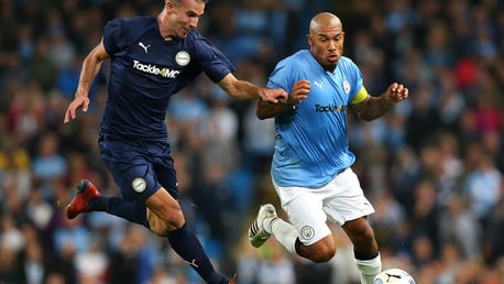 Nigel De Jong takes on Robin Van Persie at Vincent Kompany's testimonial.