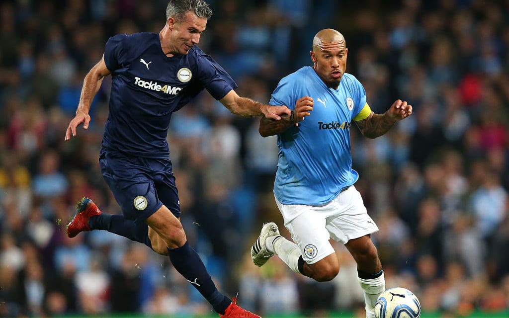 Nigel De Jong takes on Robin Van Persie at Vincent Kompany's testimonial.